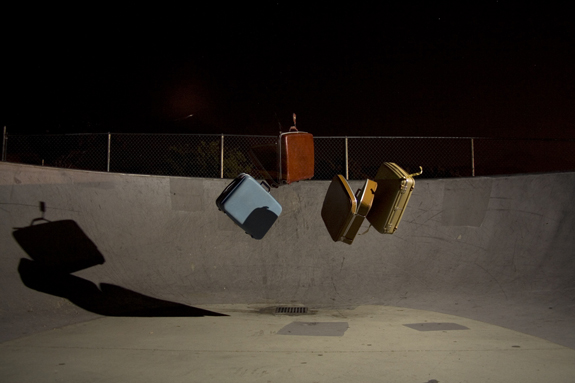 https://guernicamag.com/wp-content/uploads/2013/09/Suitcases-floating-around-at-a-skate-park.jpg