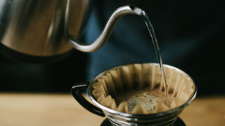 Boiling water pours into a pour-over coffee maker